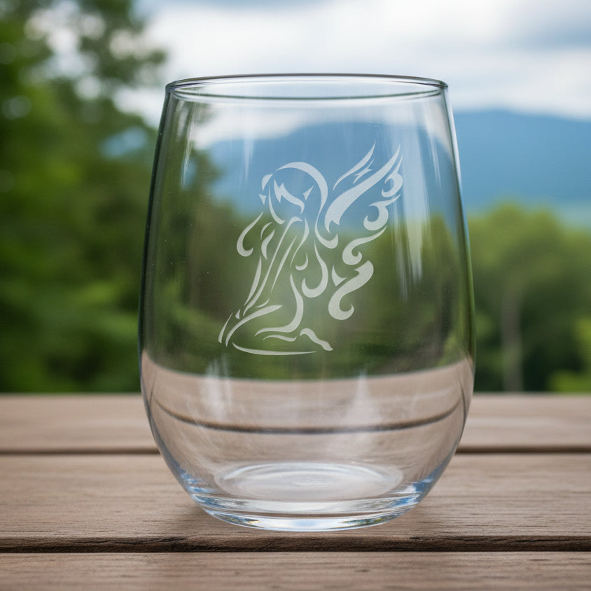 Clear glass with an angel design on a wooden surface