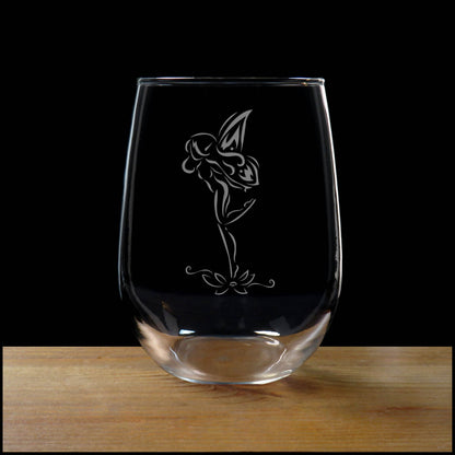 Clear glass with a Fairy etching on a wooden surface 