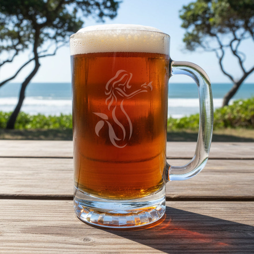 Glass mug of beer with a logo on a wooden table by the ocean