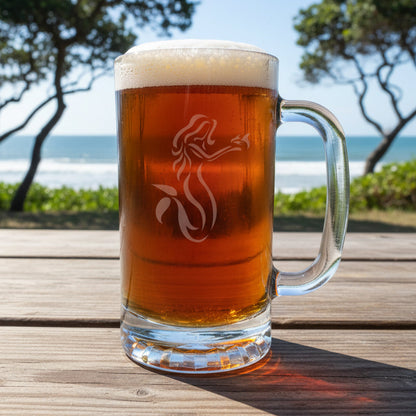 Glass mug of beer with a logo on a wooden table by the ocean