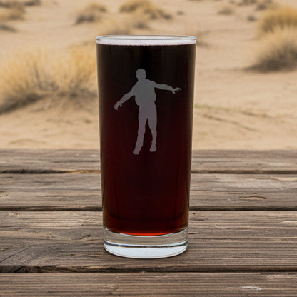 Cooler glass with white silhouette of a person with a dessert in the background