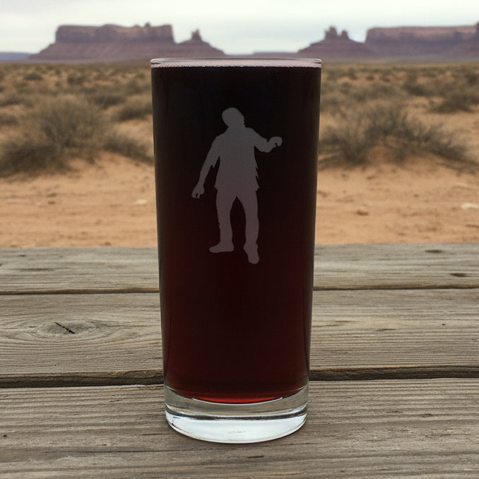 Cooler glass with white silhouette of a person with a dessert in the background
