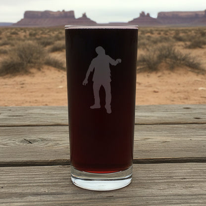 Cooler glass with white silhouette of a person with a dessert in the background