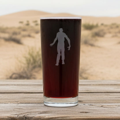Cooler glass with white silhouette of a person with a dessert in the background