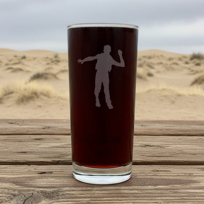 Cooler glass with white silhouette of a person with a dessert in the background