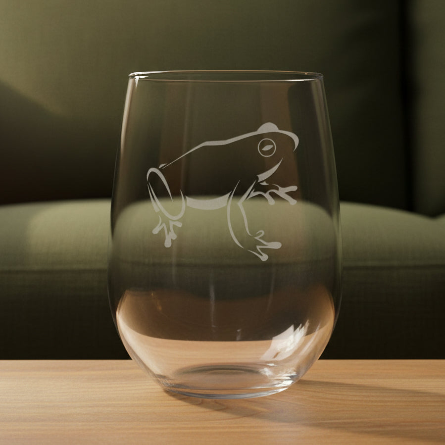 17oz Stemless Wine Glass with an etched image of a frog 
and a green couch in the background