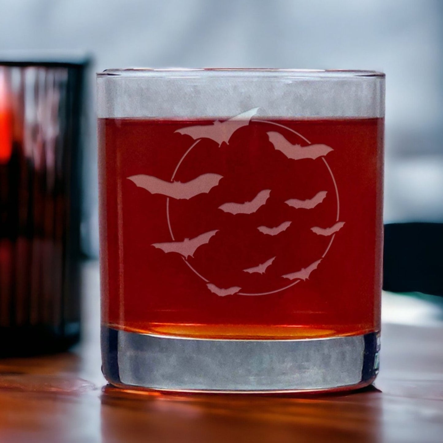 An image of an 11oz whiskey glass an image of bats flying in front of the moon