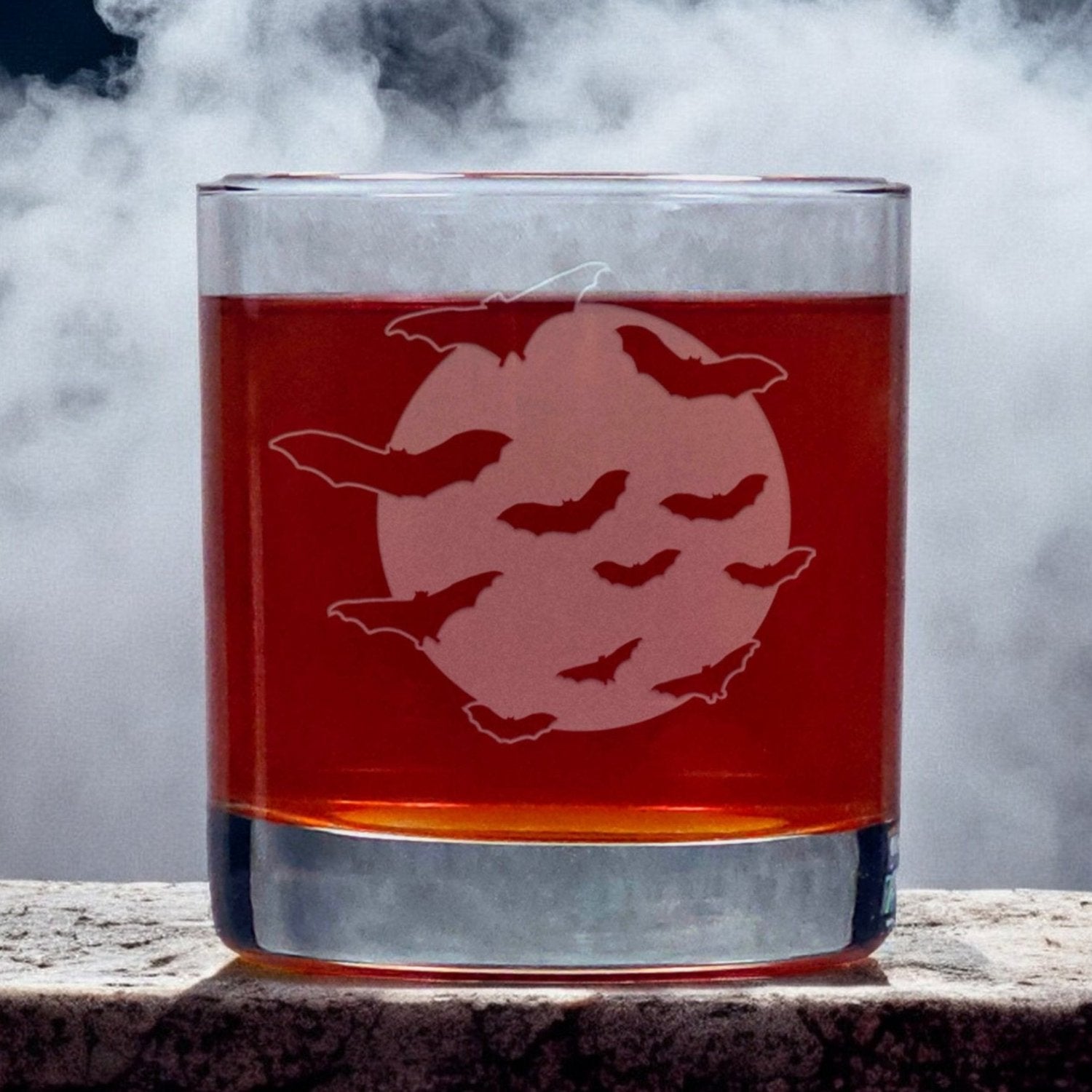 An image of an 11oz whiskey glass an image of bats flying in front of the moon
