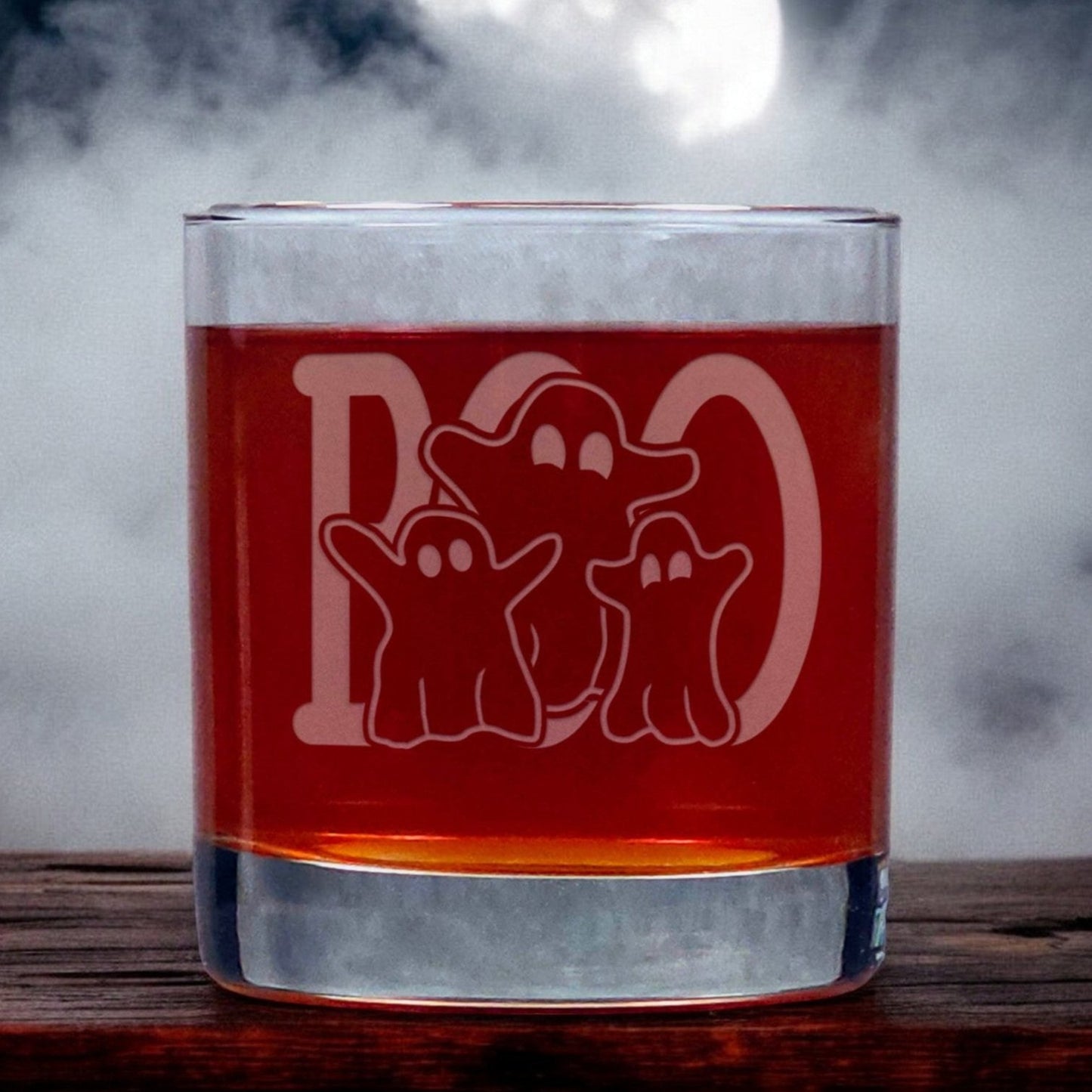 An image of an 11oz whiskey glass with a misty background with three ghosts standing in front of a large word "BOO" 