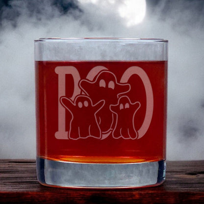 An image of an 11oz whiskey glass with a misty background with three ghosts standing in front of a large word "BOO" 