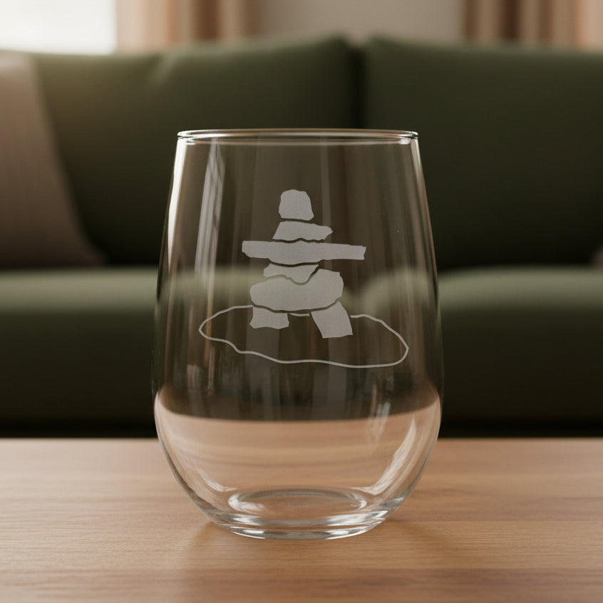 17oz Stemless Wine Glass with an etched image of an Inuksuk
and a green couch in the background