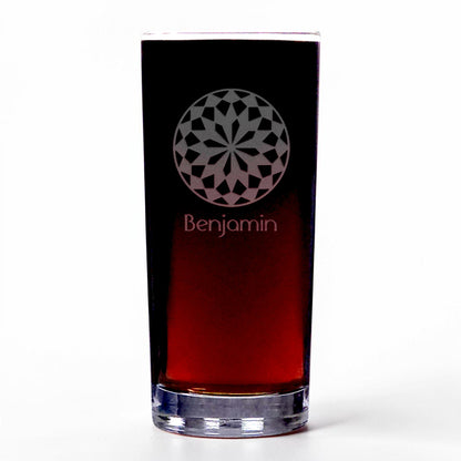 A clear highball glass featuring a circular geometric mandala pattern and the name 'Benjamin' etched below, set against a plain white background.