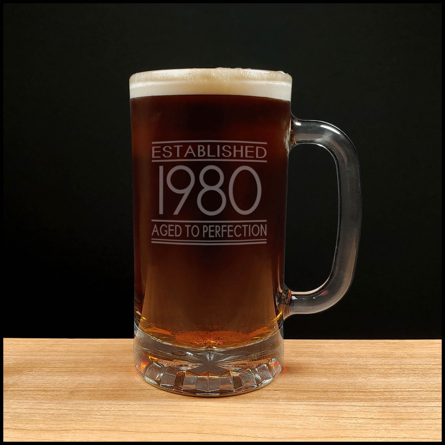 Beer mug with 'Established 1980 Aged to Perfection' text on a wooden surface 