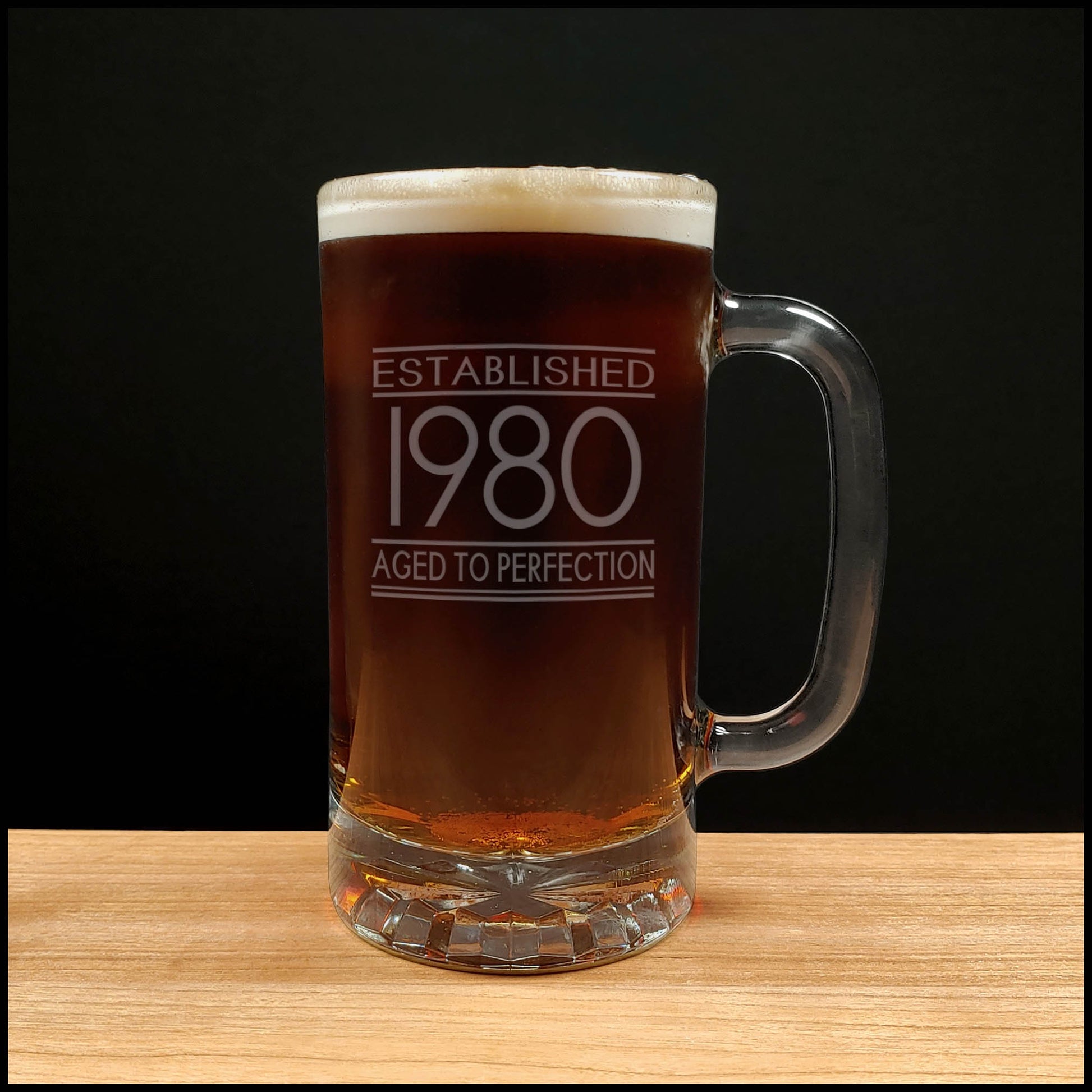 Beer mug with 'Established 1980 Aged to Perfection' text on a wooden surface 