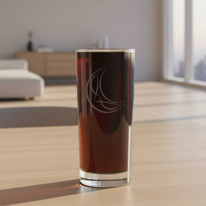A clear cooler glass filled with dark beverage, featuring an etched crescent moon and star design on the front.