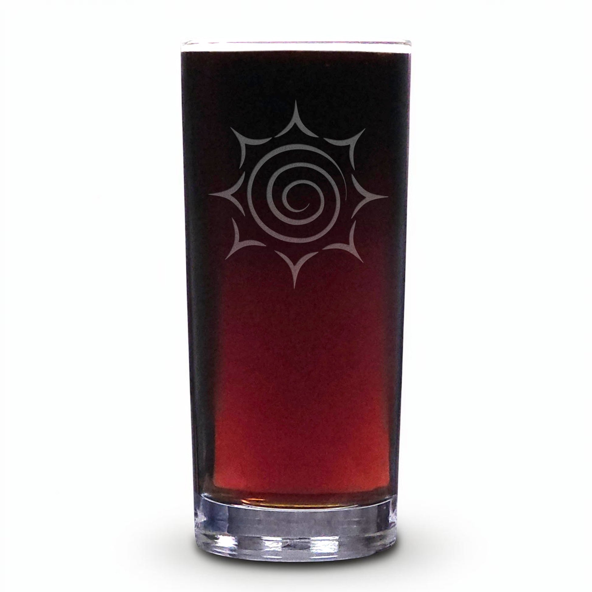 A tall, slender clear glass tumbler filled with a dark reddish-brown liquid, featuring a white etched spiral sunburst design on the front, set against a plain white background.