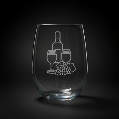 A clear stemless wine glass with a white etched graphic of a wine bottle, two wine glasses, and a grape cluster, shown  against a black background.