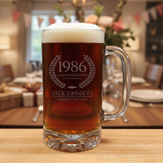 Glass mug with beer and engraved text on a wooden surface