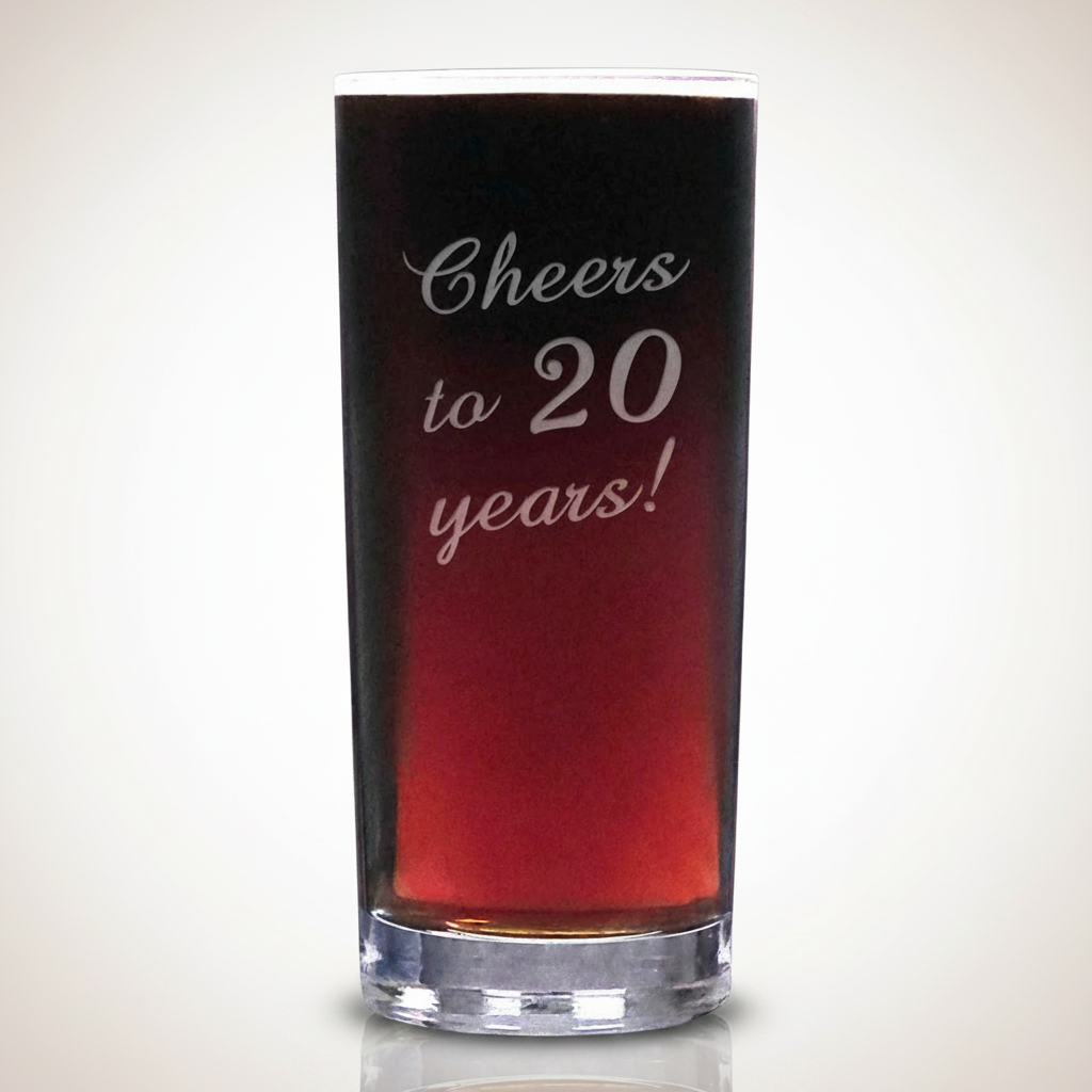 Glass with red liquid and 'Cheers to 20 years!' text on a white background