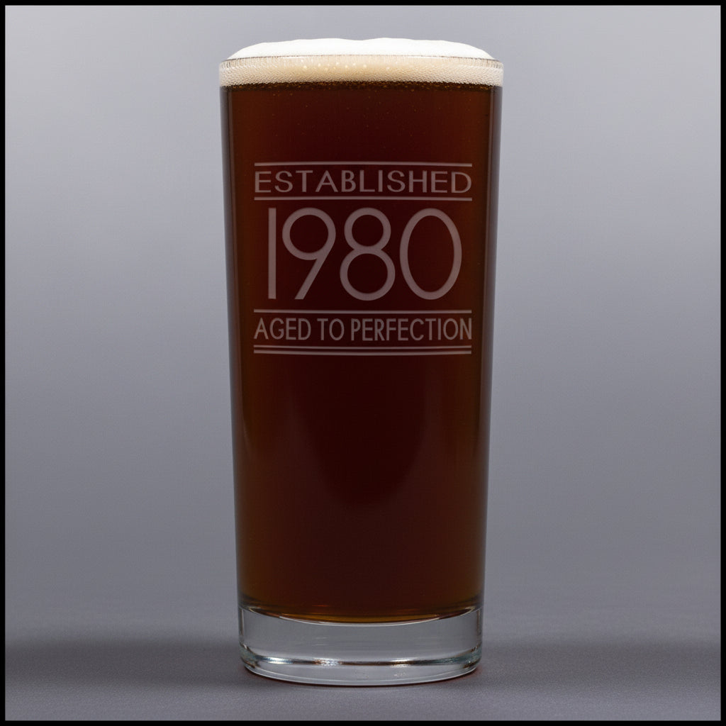 Glass with 'Established 1980 Aged to Perfection' text on a gray background