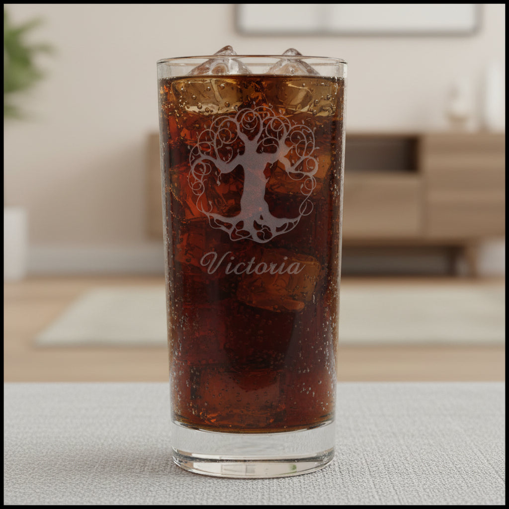 A clear cooler glass filled with dark drink, featuring an etched tree of life design and the name 'Victoria' on the front, set against a neutral background.