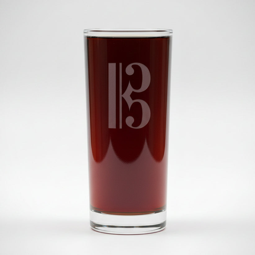 Cooler glass with a alto clef etching with a white background
