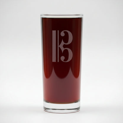 Cooler glass with a alto clef etching with a white background
