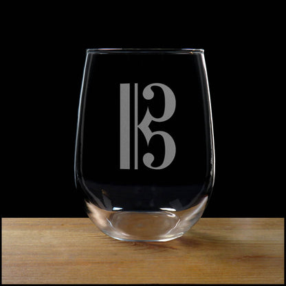 Alto Clef stemless wine glass on a wood surface with a black background