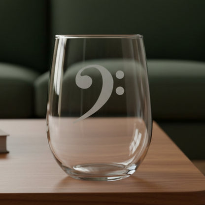 Bass Clef stemless wine glass with a green couch behind it