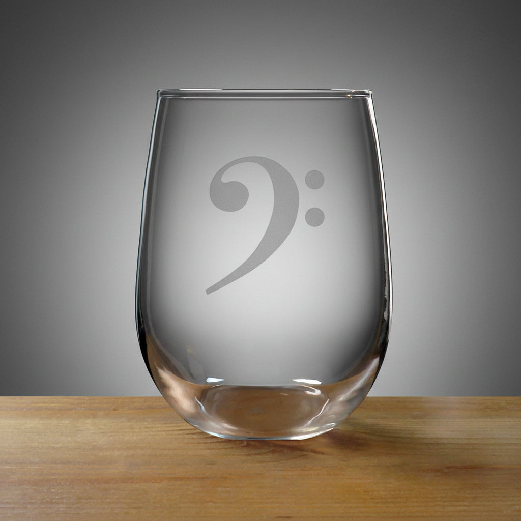 Bass Clef stemless wine glass on a wood surface with a black background