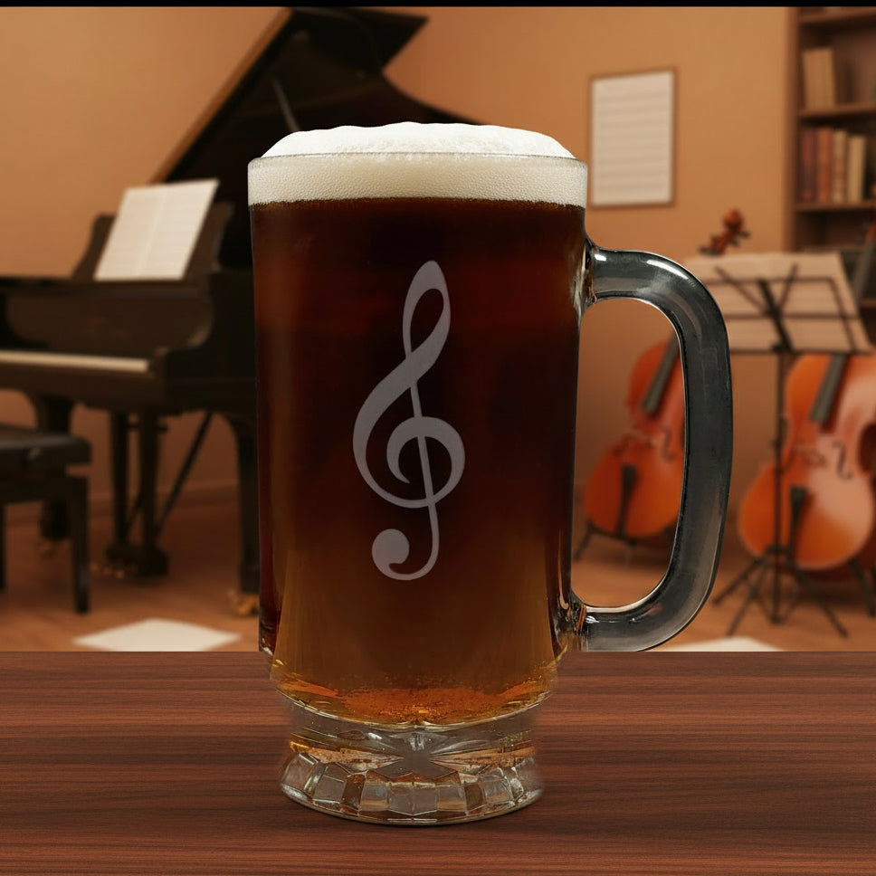Glass mug with a treble clef engraving filled with dark beer on a wooden surface with a music room in the background