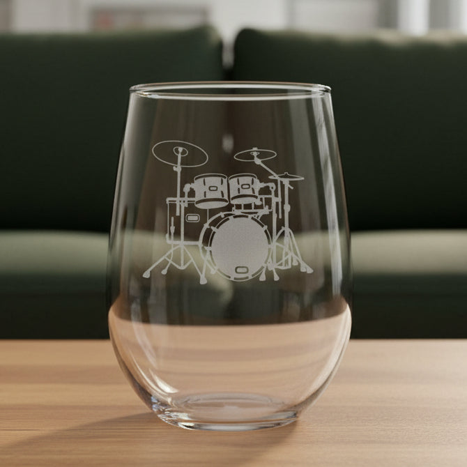 Drum Set stemless wine glass with a green couch behind it