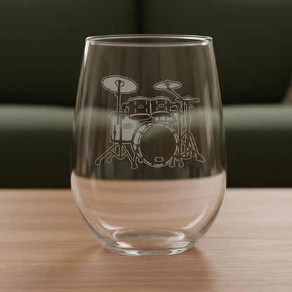 Drum Set stemless wine glass with a green couch behind it