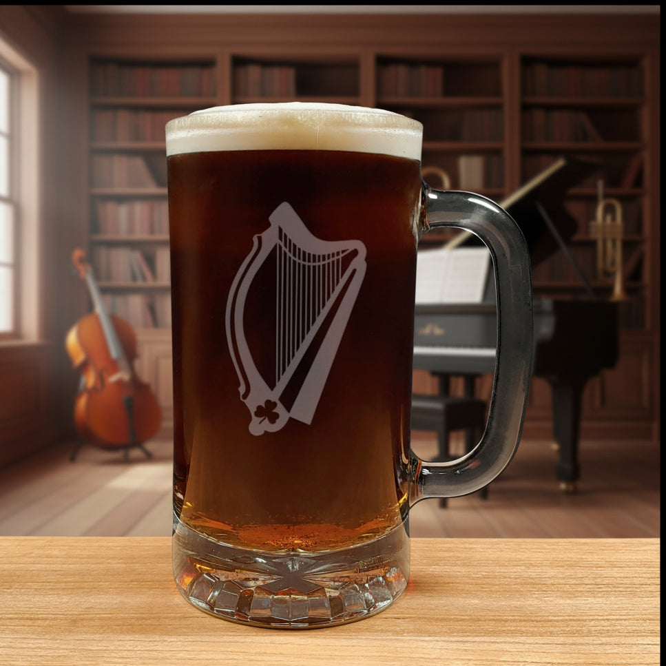 Glass mug with a harp engraving filled with dark beer on a wooden surface with a music room in the background