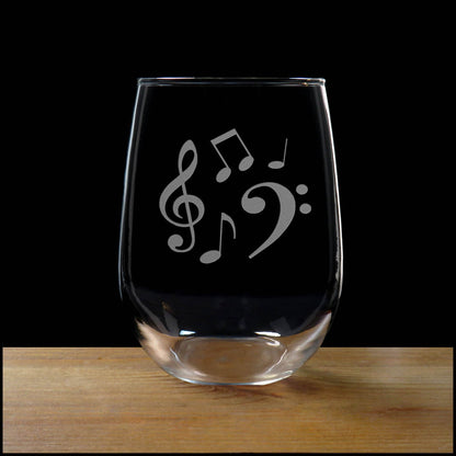 Stemless wine glass with etched Music Notes Design on a wood surface with a black background