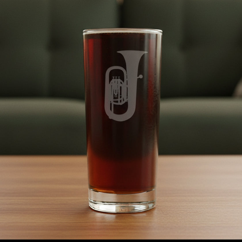 Cooler glass with a sand etched image of a tuba - with a green couch in the background