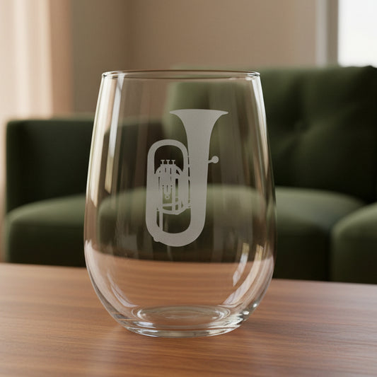 Tuba stemless wine glass with a green couch behind it