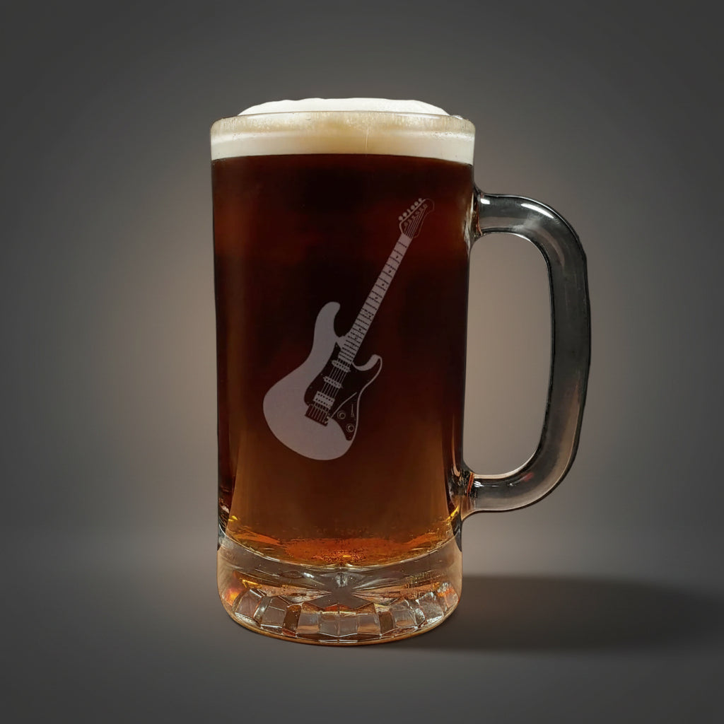 Glass mug with a guitar engraving filled with dark beer on a wooden surface.
