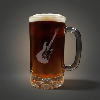 Glass mug with a guitar engraving filled with dark beer on a wooden surface.