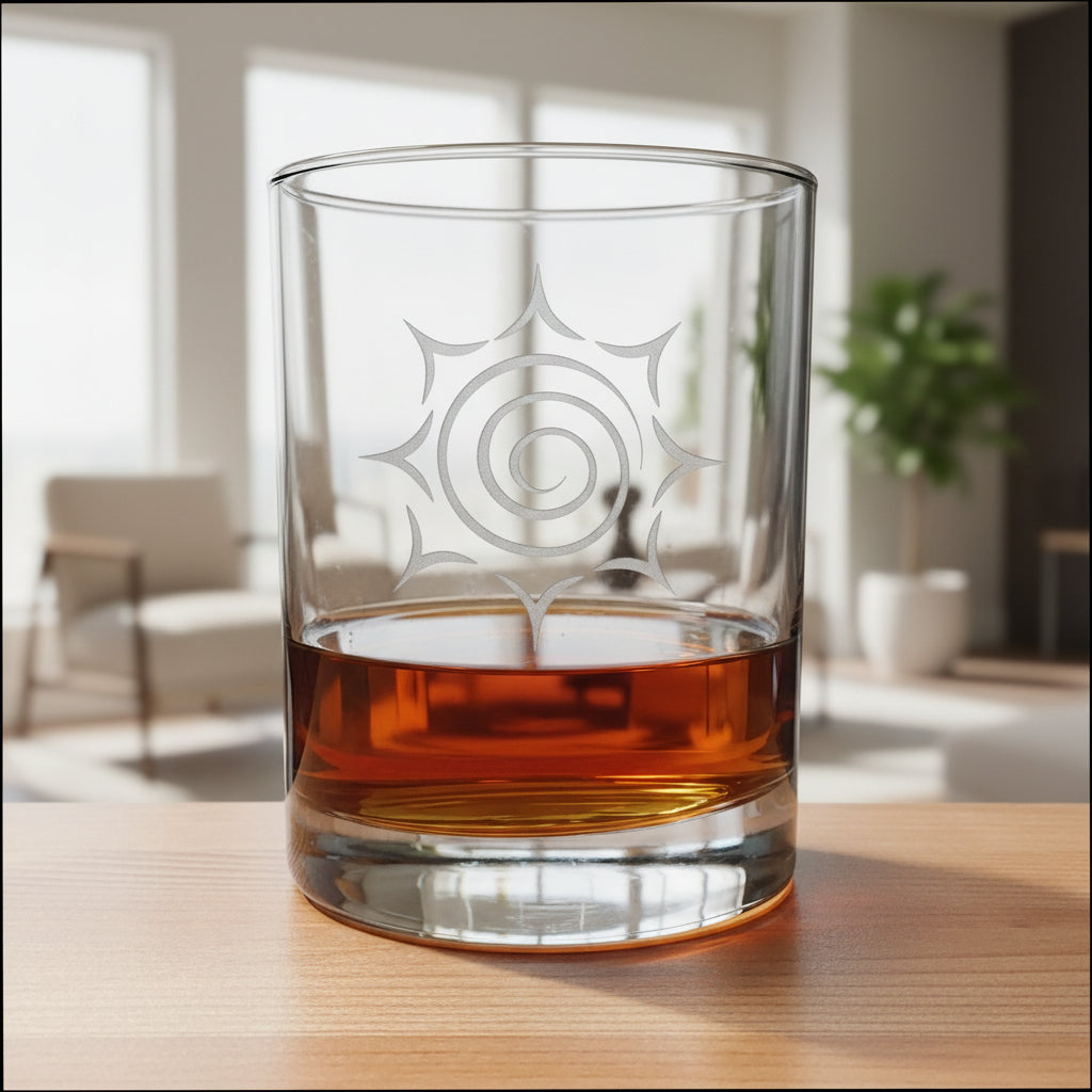 A clear glass rocks tumbler with a white spiral sunburst design, partially filled with amber whiskey, set on a wooden surface against a bright living room
