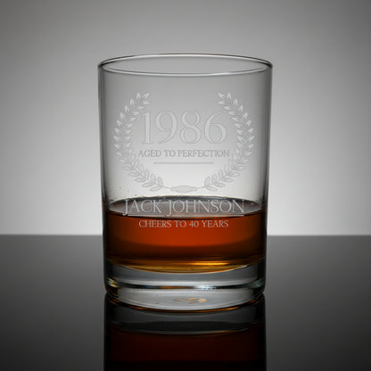 Whiskey glass with engraved text '1986 Aged to Perfection' and 'Jack Johnson Cheers to 40 Years' 