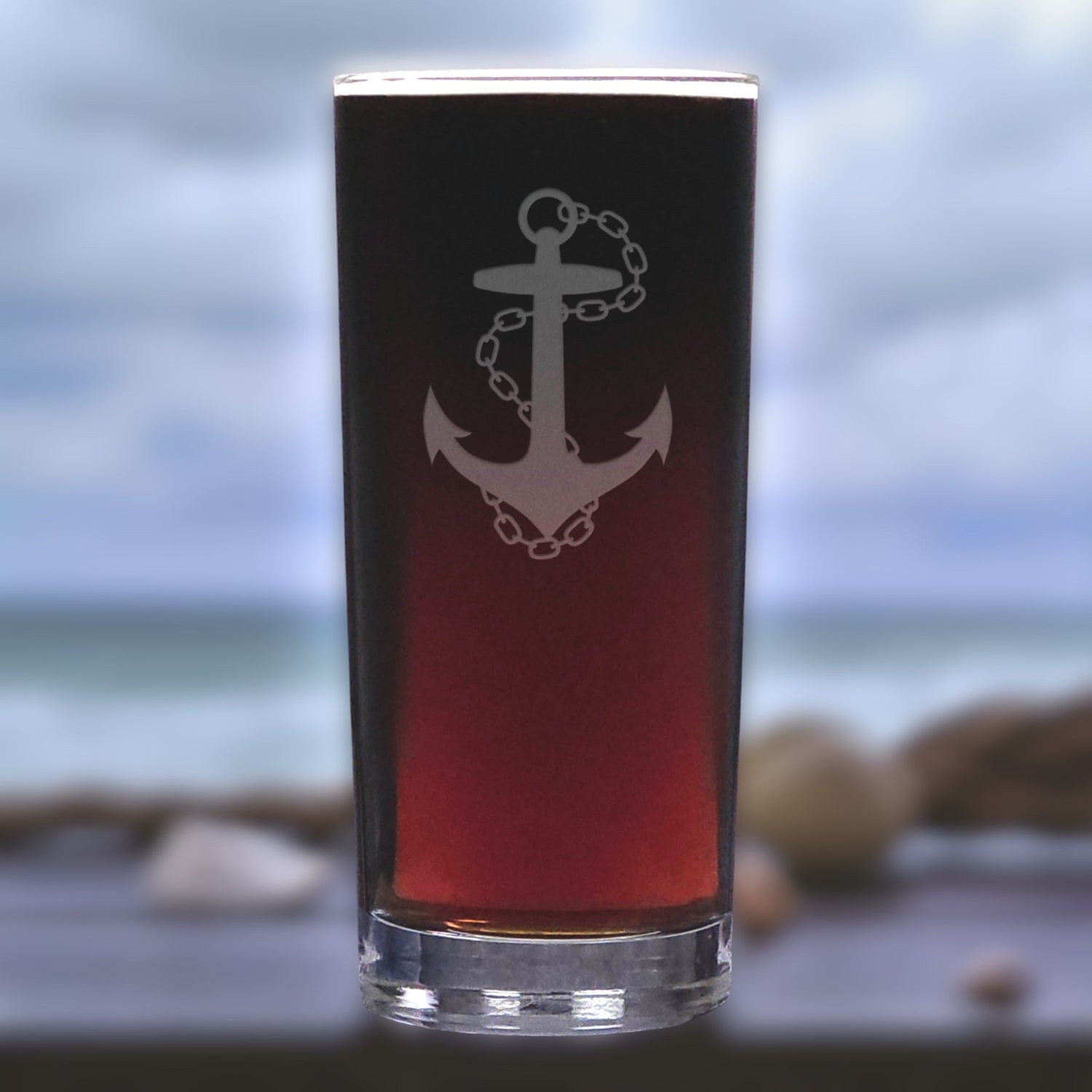 Glass with anchor design on a blurred beach background