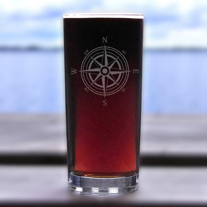 Glass with a compass design on a blurred outdoor background