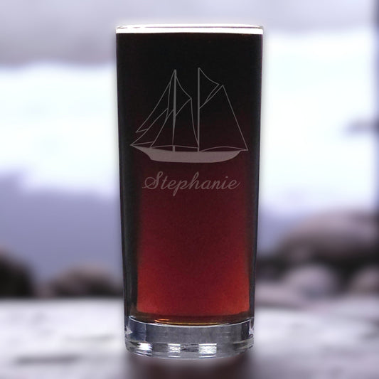 Black glass with sailboat design and 'Stephanie' engraving on a blurred background
