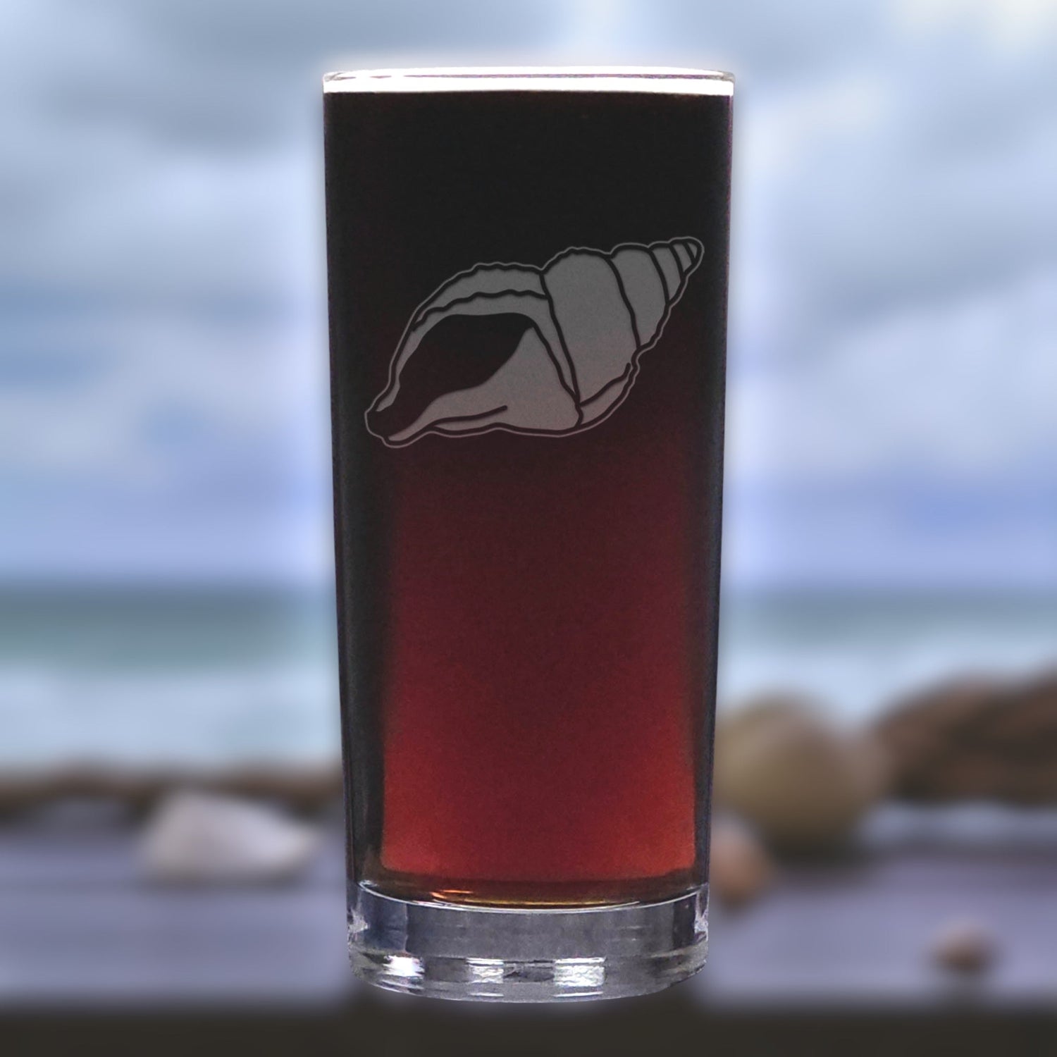 Glass with a shell design on a beach background