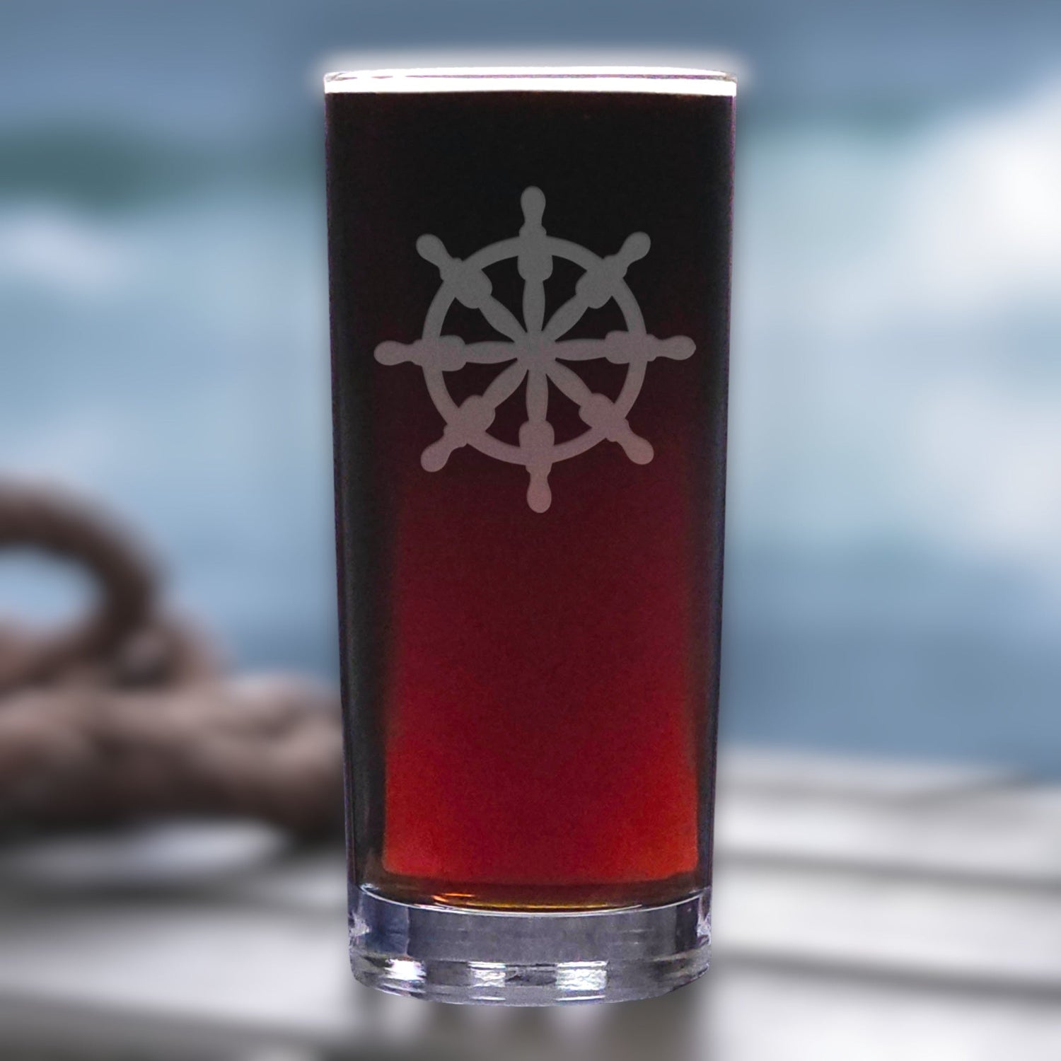 Glass with a ship's wheel design on a blurred background