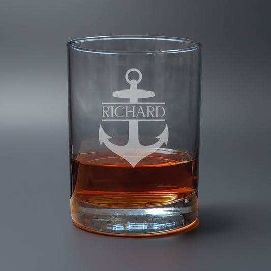 Clear glass tumbler with anchor design and 'Richard' text, filled with a brown liquid 
