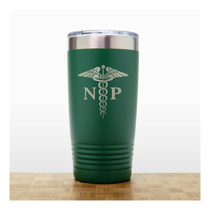 A dark green insulated travel tumbler with a stainless steel lid, With an laser engraved  medical caduceus symbol with the letters 'NP' on the front. The tumbler is shown standing on a wooden surface against a white background.