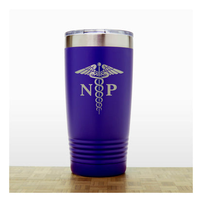 A purple insulated travel tumbler with a stainless steel lid, With an laser engraved  medical caduceus symbol with the letters 'NP' on the front, standing on a wooden surface against a white background.