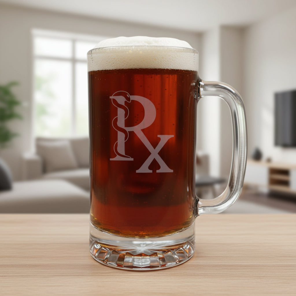 A clear glass beer mug with a handle, filled with dark amber beer and topped with white foam, featuring a etched Rx symbol on the front, set on a light wood surface against a black background.